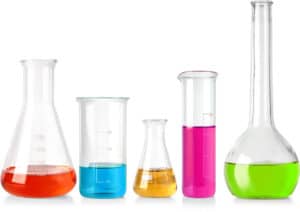 Five various sizes and shapes of science beakers with colorful liquid inside on a white background