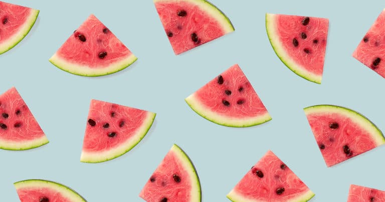 Triangle shaped watermelon slices in a pattern on a Juiced Rite brand blue background.