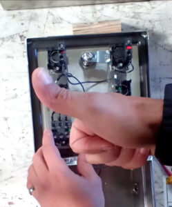 Thumbs Up In Front of Backside of Control Box for a Juiced Rite Cold Press Machine
