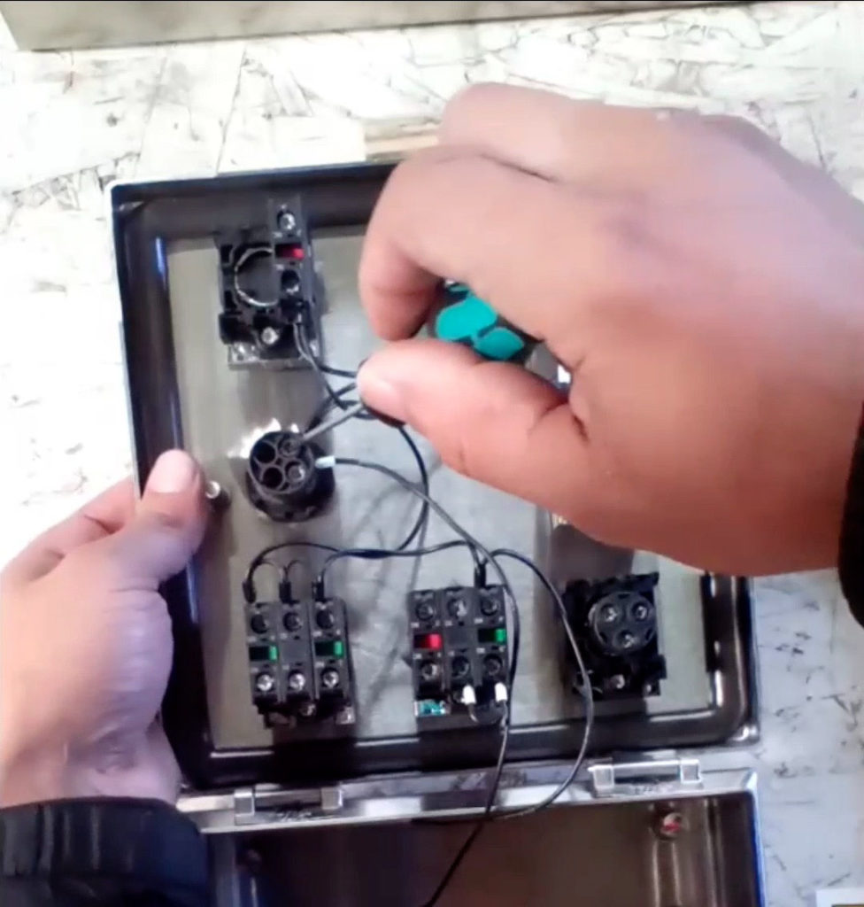 A Demonstration of Removing the Screws That Hold in the Terminal Wires