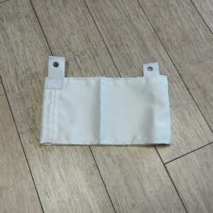 White fabric pIn and hook shredder skirt laying on wood flooring
