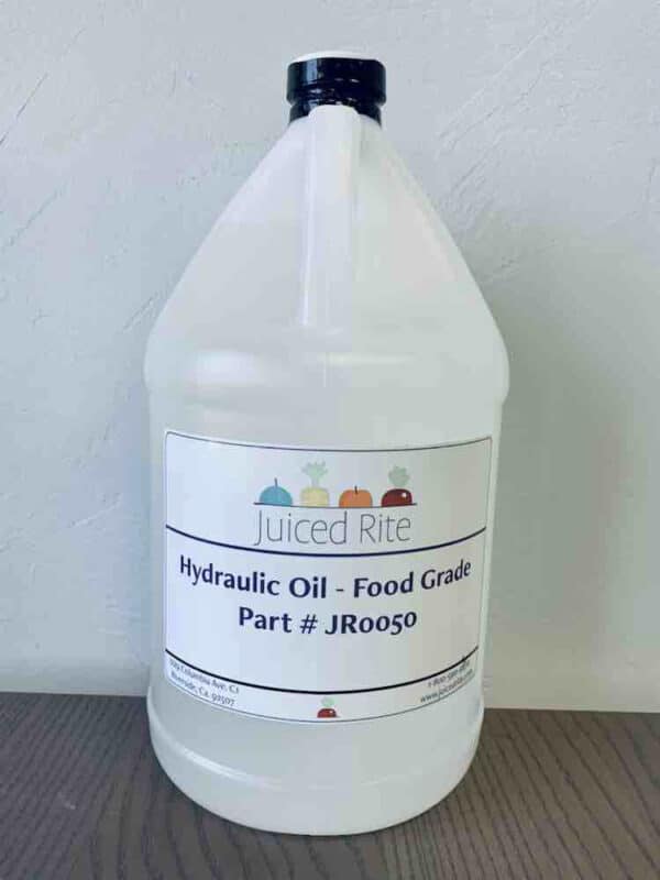 Gallon of hydraulic oil with Juiced Rite label on a wood table with a grey wall background