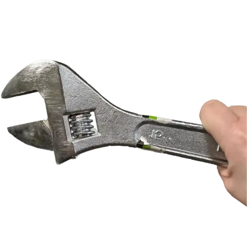 Photo of half a hand holding a wrench